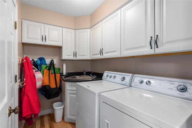 1125 N Franklin St, Litchfield, IL 62056 - washroom with washing machine and dryer, light wood-style flooring, and a sink