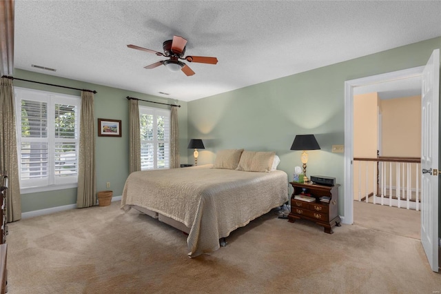 1125 N Franklin St, Litchfield, IL 62056 - bedroom with light colored carpet, baseboards, a textured ceiling, and a ceiling fan