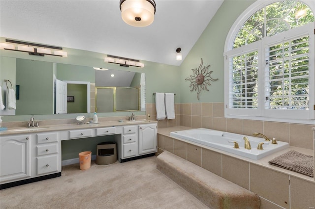 1125 N Franklin St, Litchfield, IL 62056 - full bathroom with a shower stall, lofted ceiling, double vanity, and a garden tub