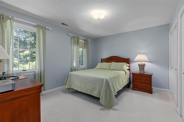 1125 N Franklin St, Litchfield, IL 62056 - carpeted bedroom with a textured ceiling, baseboards, and a closet