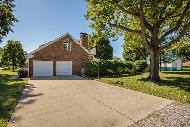 1125 N Franklin St, Litchfield, IL 62056 - traditional-style house featuring brick siding, a chimney, a garage, and concrete driveway