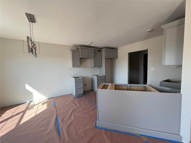 5355 Byrd Creek Trl, Jackson, MO 63755 - kitchen featuring gray cabinets, carpet floors, and hanging light fixtures