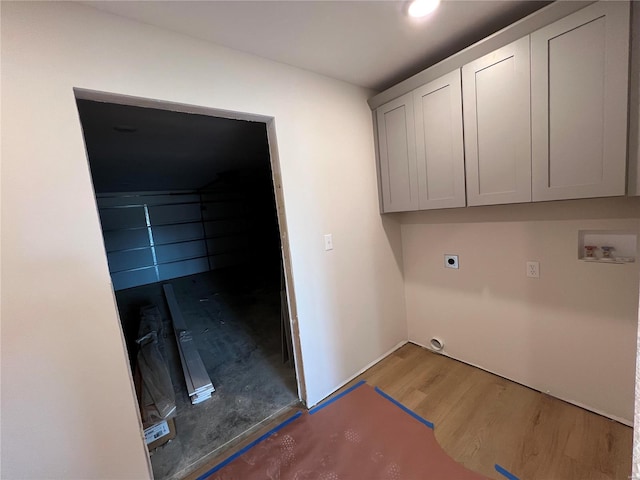 5355 Byrd Creek Trl, Jackson, MO 63755 - laundry room featuring hookup for an electric dryer, wood finished floors, hookup for a washing machine, and cabinet space