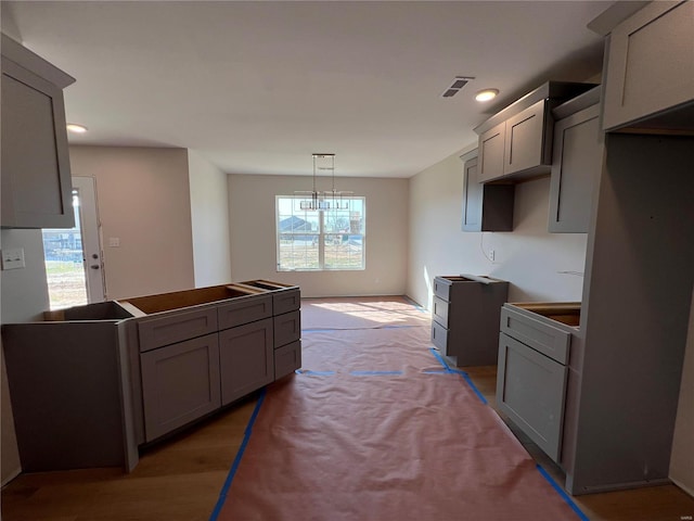 5355 Byrd Creek Trl, Jackson, MO 63755 - kitchen with gray cabinets, recessed lighting, light colored carpet, and pendant lighting