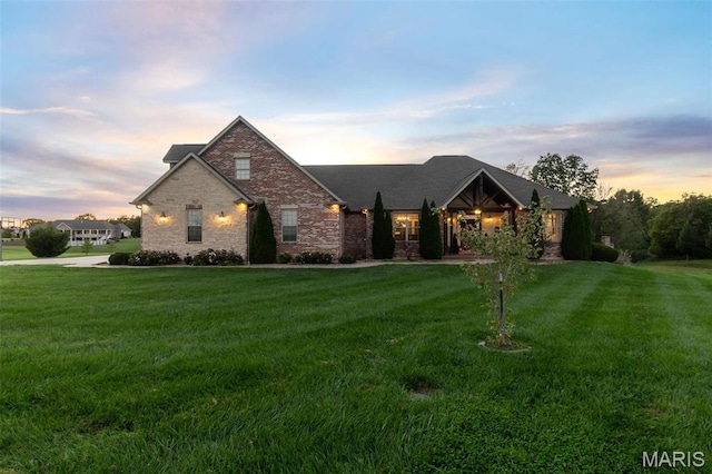 view of front of house featuring a front lawn and brick siding
