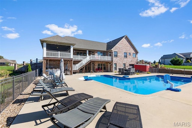 view of pool featuring stairs, fence, and a patio