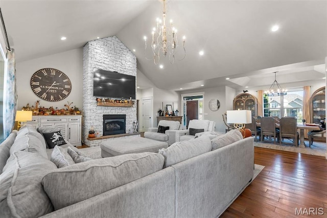 living room featuring a chandelier, dark wood-style flooring, recessed lighting, a fireplace, and high vaulted ceiling