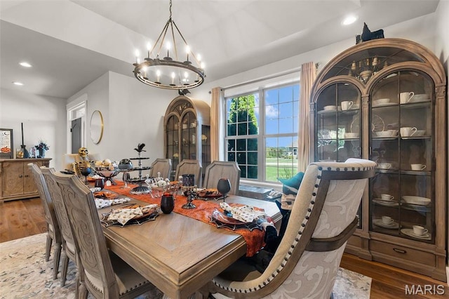 dining space with a chandelier, wood finished floors, and recessed lighting