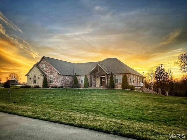 view of front of home featuring a front yard and brick siding