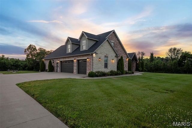 165 Kingsborough Ct, Jackson, MO 63755 - property exterior at dusk featuring a yard, driveway, and brick siding