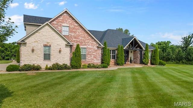 165 Kingsborough Ct, Jackson, MO 63755 - craftsman house with stone siding, a front yard, and brick siding
