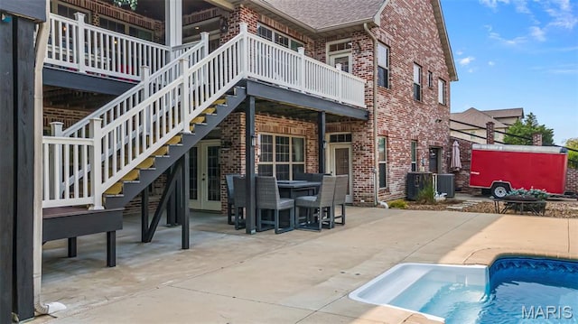 165 Kingsborough Ct, Jackson, MO 63755 - back of property with brick siding, stairs, roof with shingles, and an outdoor pool