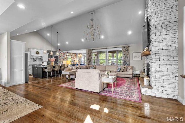 165 Kingsborough Ct, Jackson, MO 63755 - living area with high vaulted ceiling, a fireplace, dark wood-style flooring, a chandelier, and recessed lighting