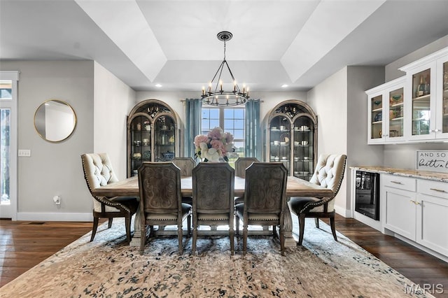 165 Kingsborough Ct, Jackson, MO 63755 - dining space with wine cooler, a tray ceiling, a chandelier, dark wood-type flooring, and recessed lighting