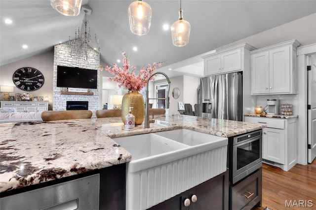165 Kingsborough Ct, Jackson, MO 63755 - kitchen featuring stainless steel refrigerator with ice dispenser, open floor plan, light wood-style flooring, white cabinets, and light stone counters