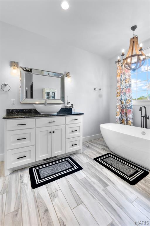 165 Kingsborough Ct, Jackson, MO 63755 - bathroom with vanity, a soaking tub, a chandelier, recessed lighting, and wood finished floors