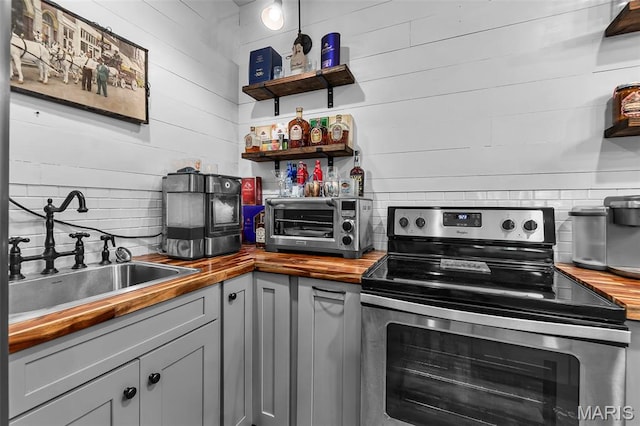 165 Kingsborough Ct, Jackson, MO 63755 - kitchen with butcher block counters, electric range, decorative backsplash, and open shelves