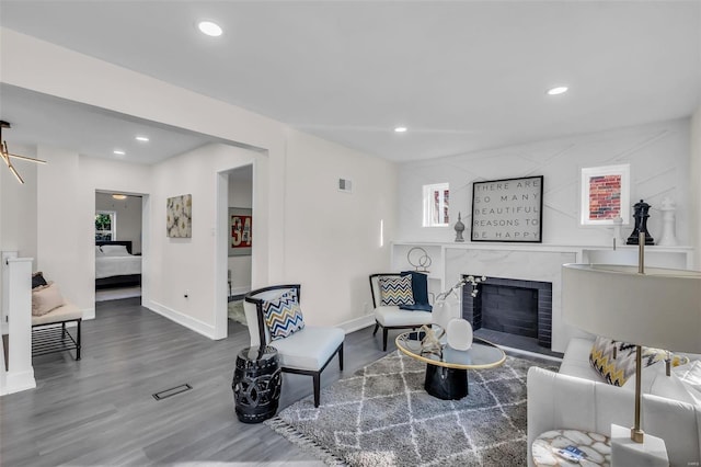 7449 Wayne Ave, Saint Louis, MO 63130 - living room featuring plenty of natural light, wood finished floors, recessed lighting, baseboards, and a high end fireplace