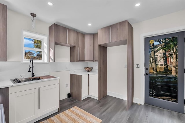 7449 Wayne Ave, Saint Louis, MO 63130 - kitchen featuring a sink, dark wood-style floors, light countertops, recessed lighting, and pendant lighting