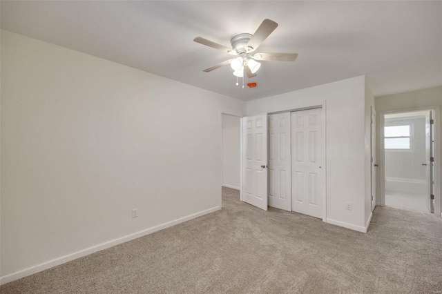 unfurnished bedroom featuring carpet flooring, baseboards, and a closet
