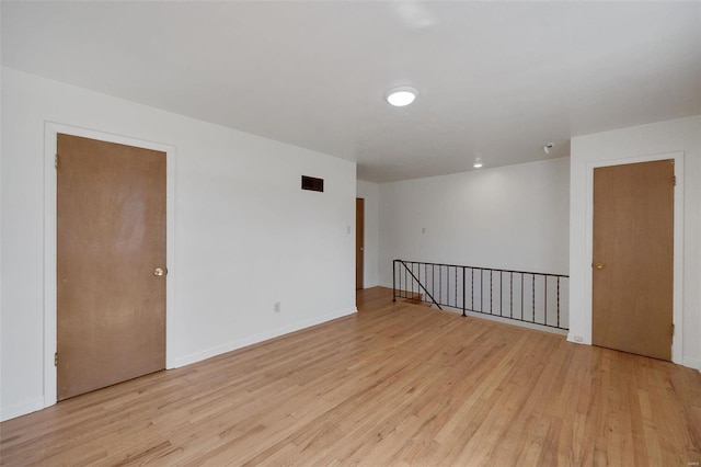 spare room with light wood-type flooring and baseboards