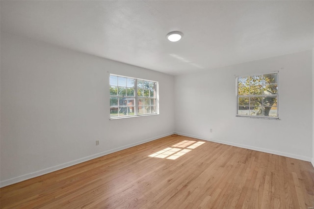 unfurnished room with wood finished floors and baseboards