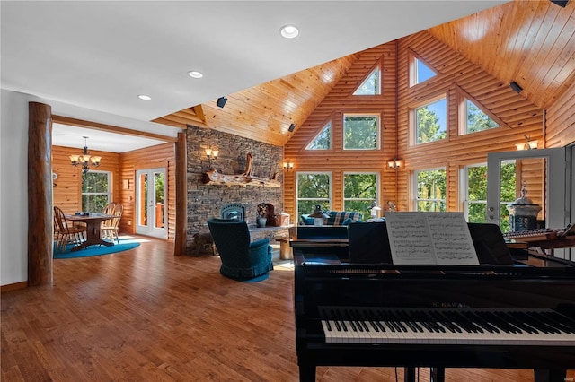 6800 Promise Pt, House Springs, MO 63051 - living area featuring high vaulted ceiling, a chandelier, wood finished floors, a stone fireplace, and recessed lighting