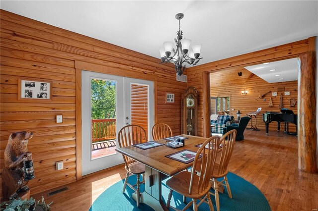 6800 Promise Pt, House Springs, MO 63051 - dining area featuring plenty of natural light, a chandelier, light wood-style flooring, and log walls