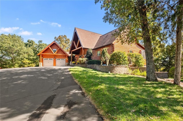 6800 Promise Pt, House Springs, MO 63051 - log-style house featuring an outdoor structure, log exterior, asphalt driveway, a garage, and a front lawn