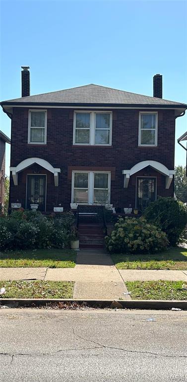 view of front of house featuring a chimney