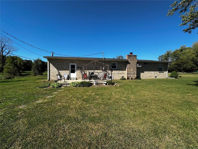 512 Odell Ave, Bismarck, MO 63624 - back of property with a patio area, a lawn, and a chimney