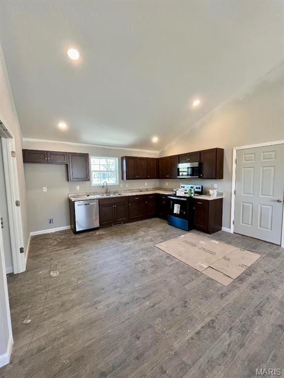 kitchen featuring appliances with stainless steel finishes, dark brown cabinets, light countertops, baseboards, and wood finished floors