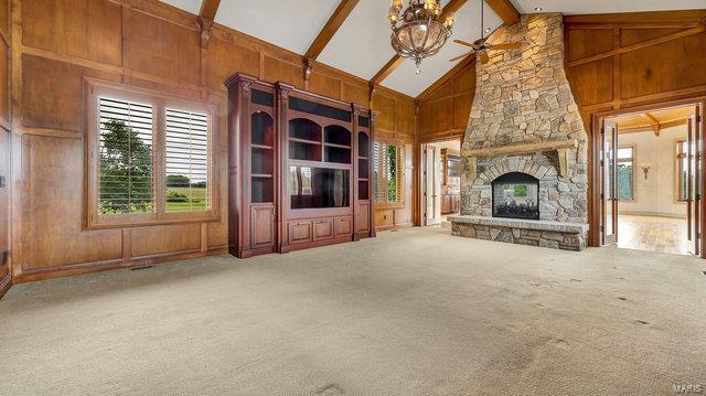 962 Hwy W, Foristell, MO 63348 - unfurnished living room featuring ceiling fan, high vaulted ceiling, plenty of natural light, carpet, and beamed ceiling