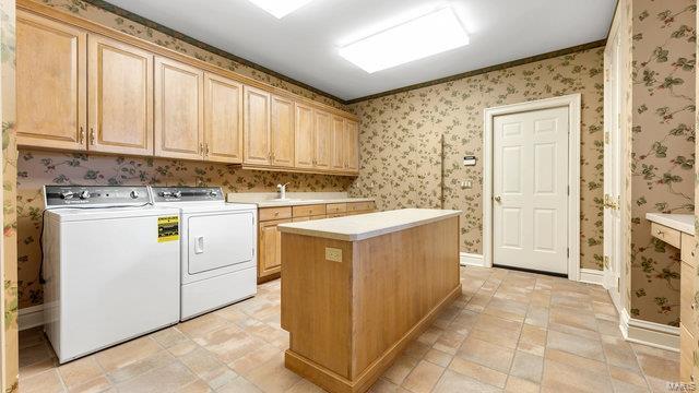 962 Hwy W, Foristell, MO 63348 - washroom featuring cabinet space, washing machine and dryer, wallpapered walls, and baseboards