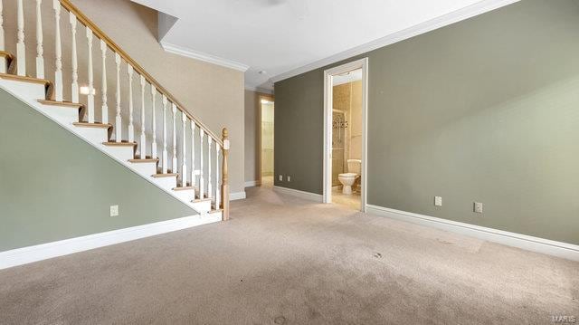 962 Hwy W, Foristell, MO 63348 - unfurnished living room featuring ornamental molding, carpet flooring, baseboards, and stairway
