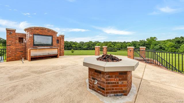 962 Hwy W, Foristell, MO 63348 - view of patio / terrace with a fire pit and fence