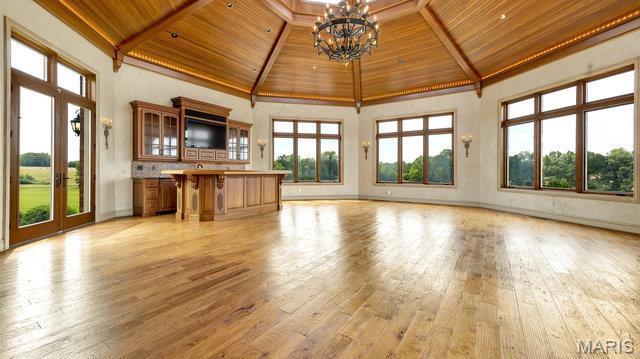 962 Hwy W, Foristell, MO 63348 - unfurnished living room with a wooden ceiling with exposed beams, high vaulted ceiling, a chandelier, plenty of natural light, and light wood finished floors