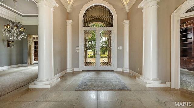 962 Hwy W, Foristell, MO 63348 - tiled foyer with french doors, ornate columns, a towering ceiling, and crown molding