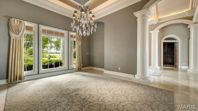 962 Hwy W, Foristell, MO 63348 - unfurnished room with crown molding, arched walkways, decorative columns, and a chandelier
