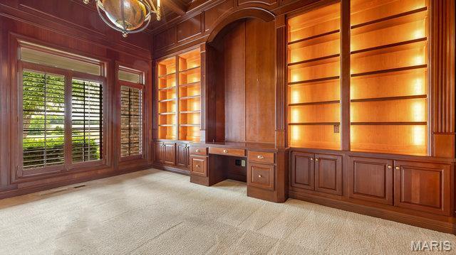 962 Hwy W, Foristell, MO 63348 - unfurnished office featuring built in desk, wooden walls, light carpet, built in features, and a chandelier