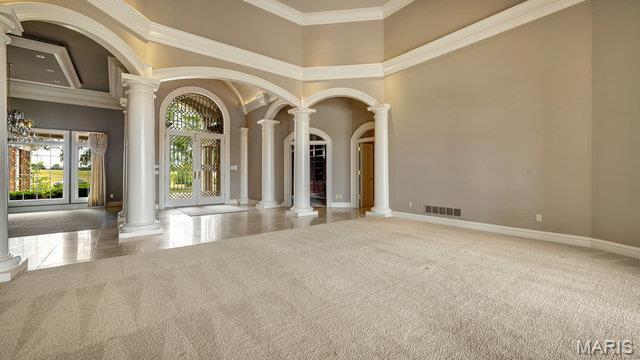 962 Hwy W, Foristell, MO 63348 - unfurnished room featuring decorative columns, a towering ceiling, and crown molding