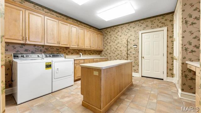 962 Hwy W, Foristell, MO 63348 - washroom with cabinet space, washing machine and clothes dryer, and wallpapered walls