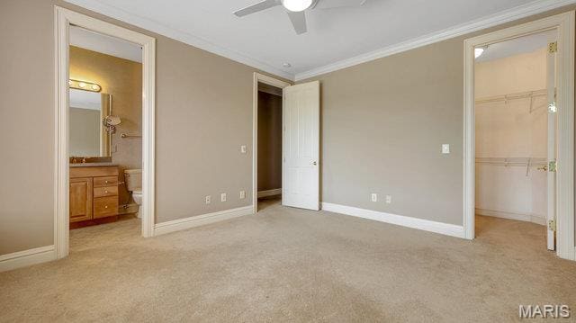 962 Hwy W, Foristell, MO 63348 - unfurnished bedroom featuring carpet floors, a walk in closet, ornamental molding, a closet, and ensuite bathroom