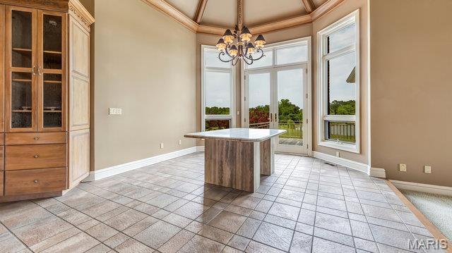 962 Hwy W, Foristell, MO 63348 - unfurnished dining area with a chandelier, crown molding, french doors, and a towering ceiling