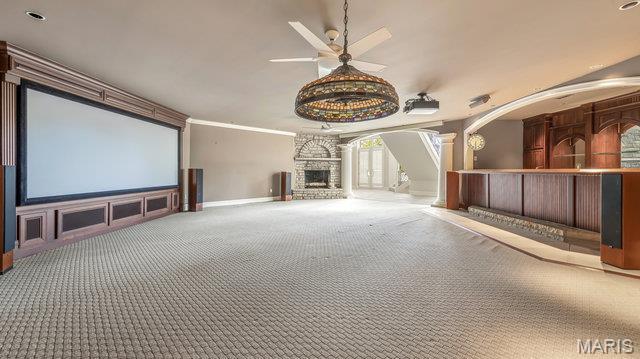 962 Hwy W, Foristell, MO 63348 - carpeted cinema room featuring crown molding, a ceiling fan, a fireplace, and decorative columns