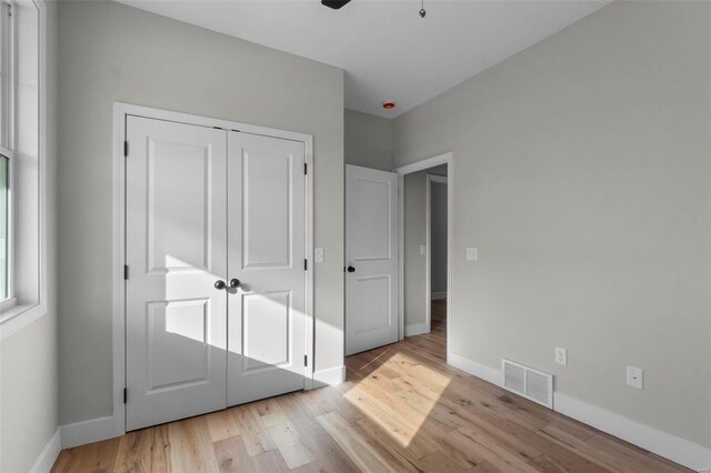 2224 Heywood Mdws, Cape Girardeau, MO 63701 - unfurnished bedroom featuring light wood finished floors, baseboards, a closet, and a ceiling fan