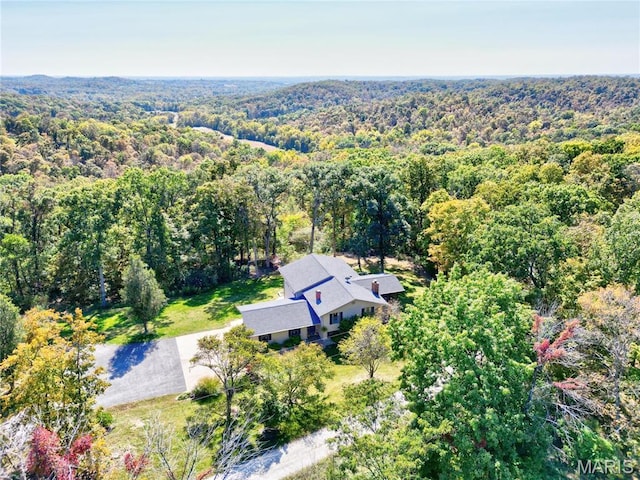 view from above of property featuring a heavily wooded area
