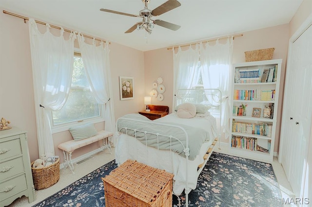bedroom with multiple windows and ceiling fan