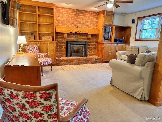 living room featuring carpet floors, ceiling fan, a brick fireplace, and built in shelves