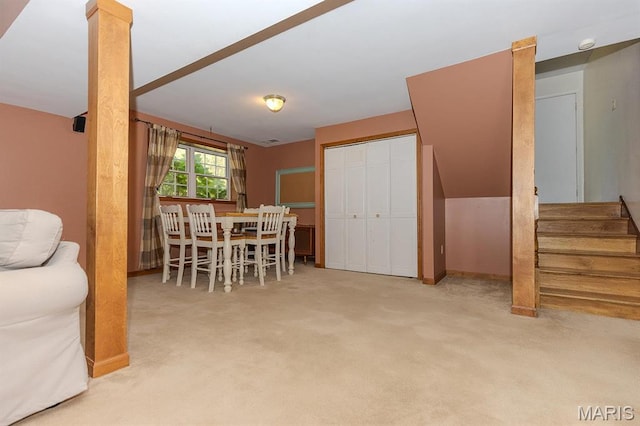 dining area featuring carpet floors, stairway, and baseboards